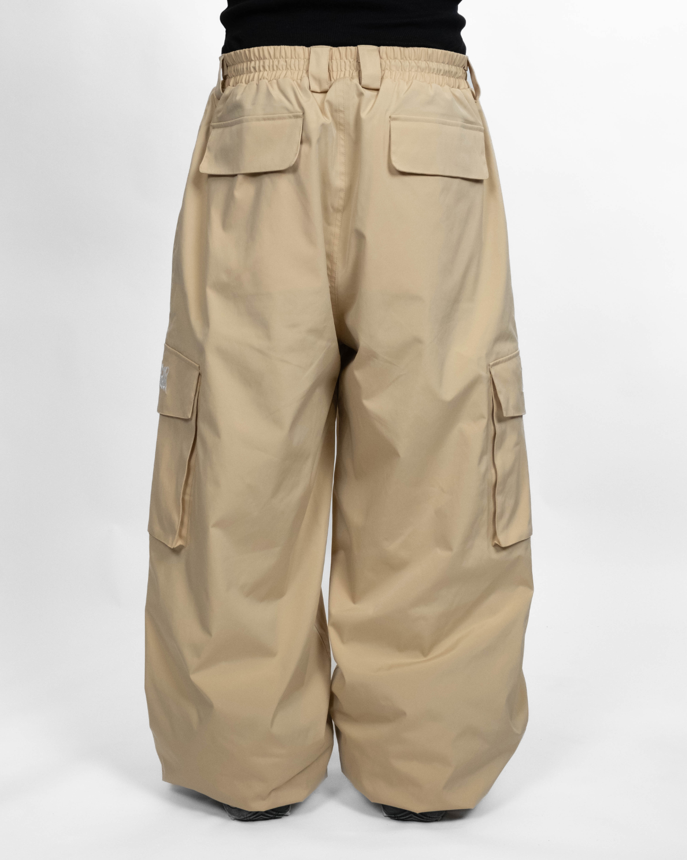 Beige baggy snowpants back view on model