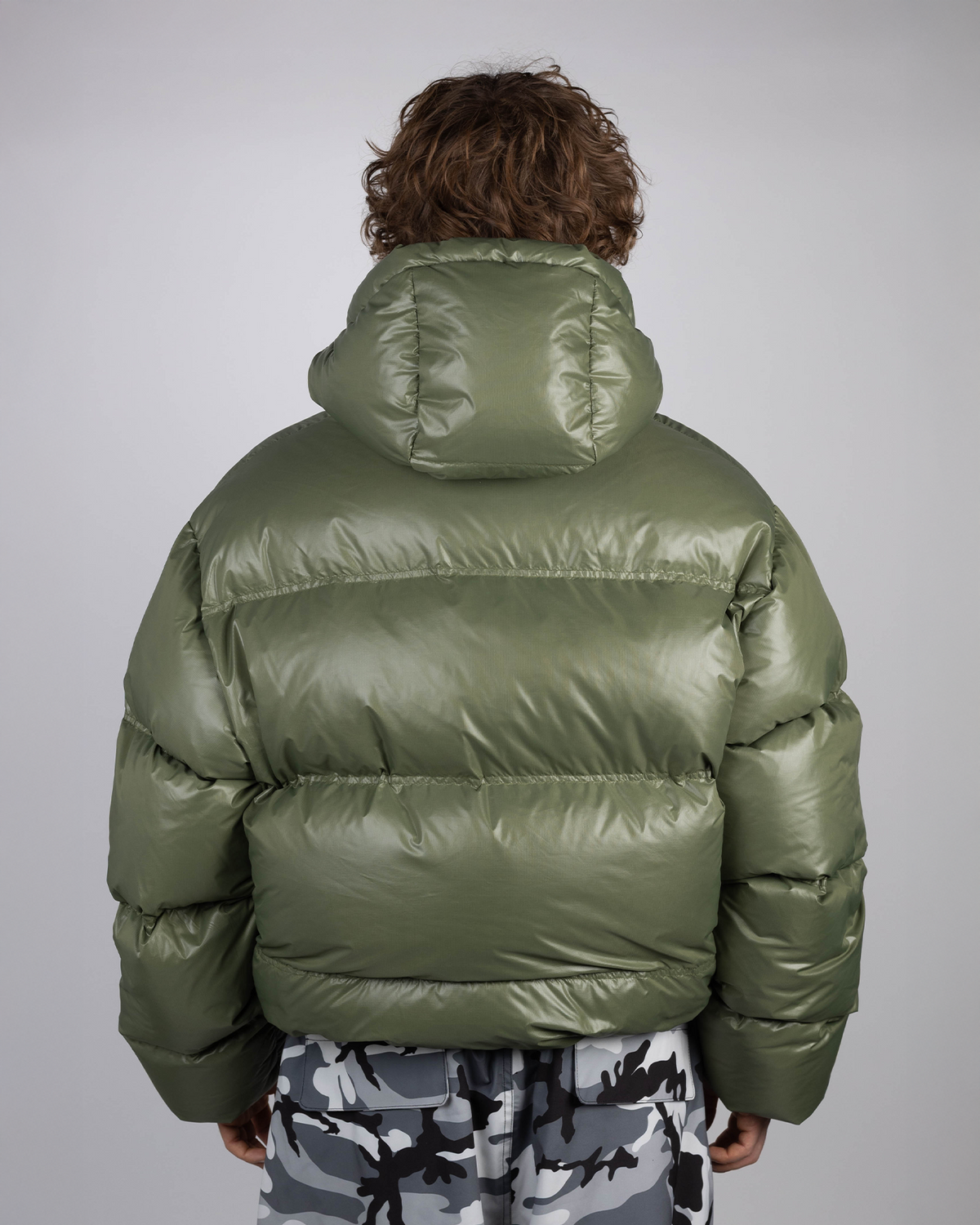 Green puffer jacket back view on model