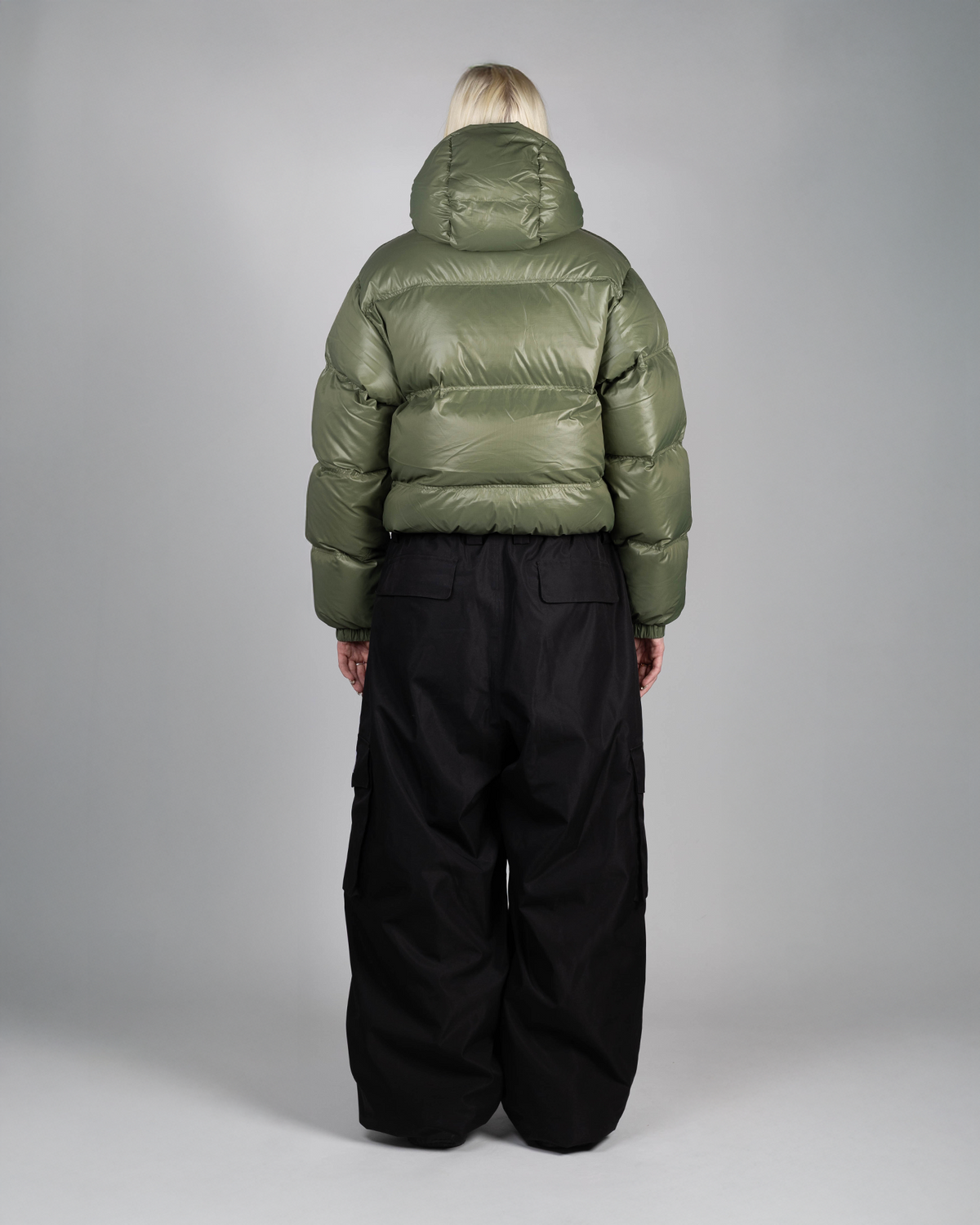 Green puffer jacket back view on a model
