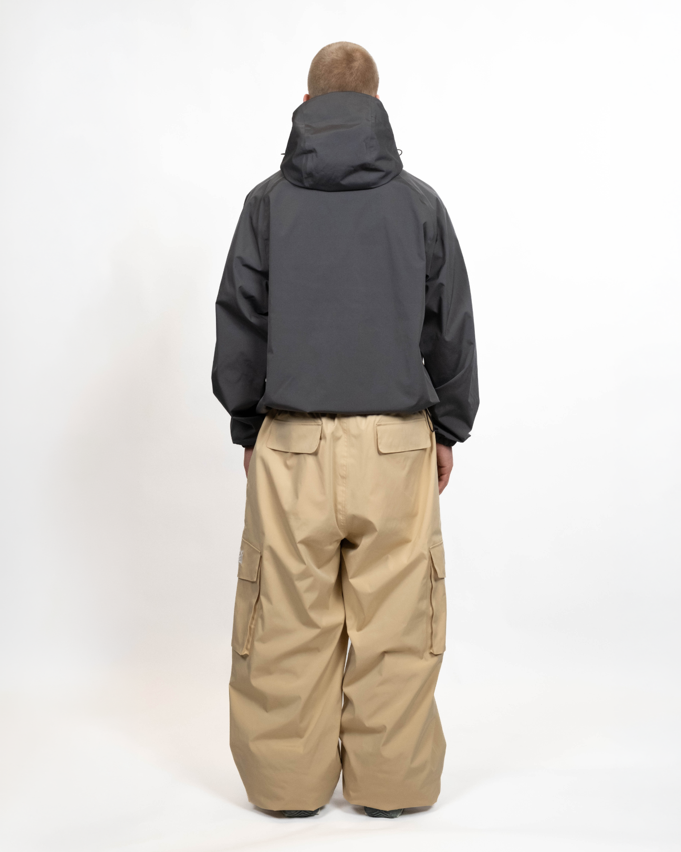 Dark grey snow jacket back view on a man
