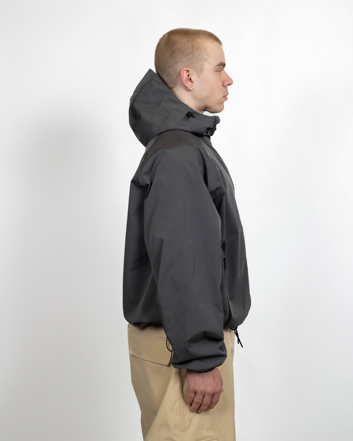 Dark grey snow jacket side view on model